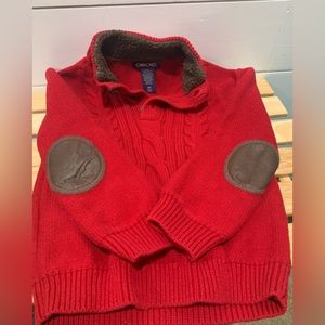 Red sweaters with brown elbow patch accents.